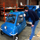 Jim Buggle of P50 Cars wipes down a replica microcar.